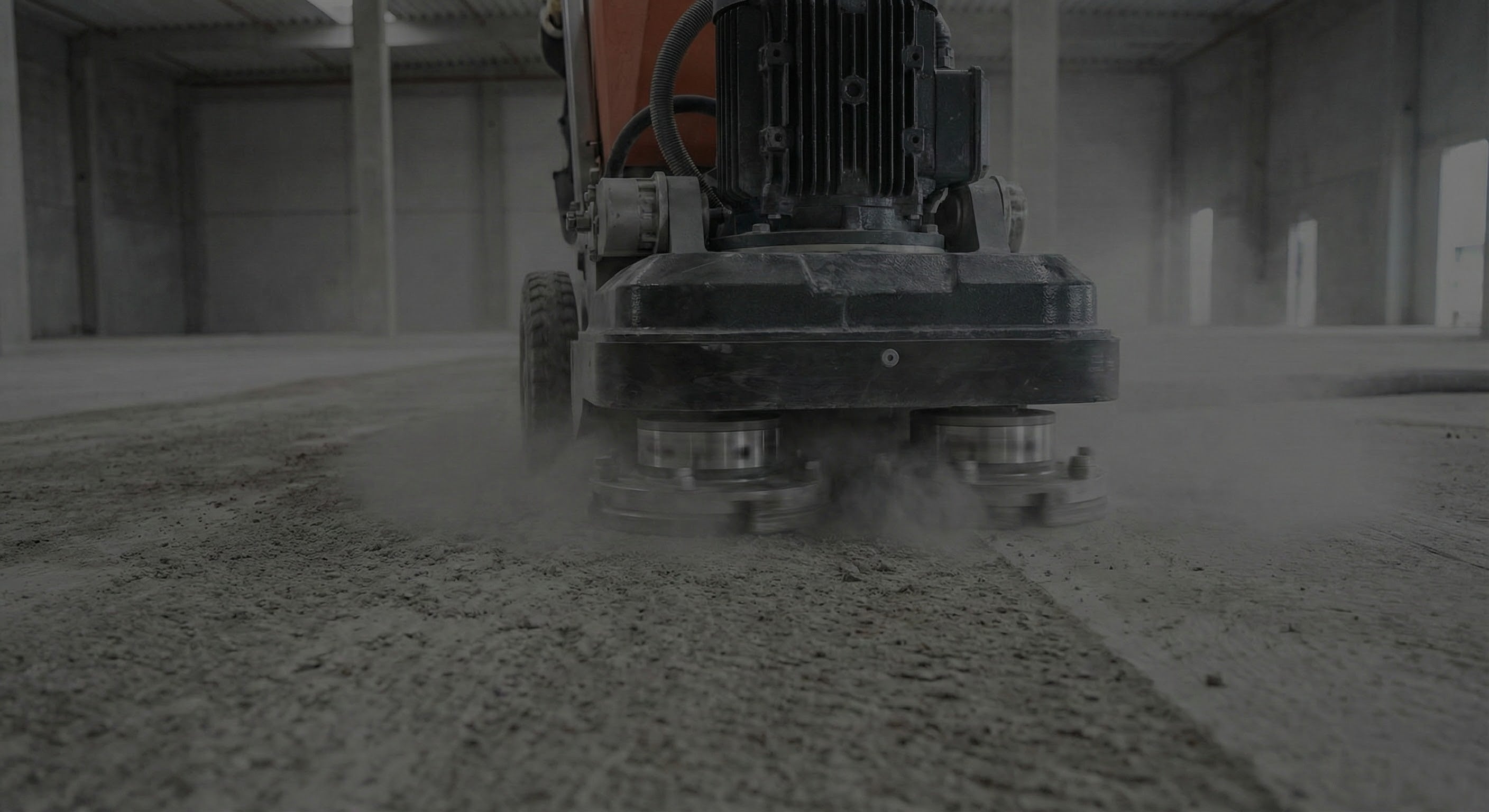 Concrete grinder in action on a concrete floor